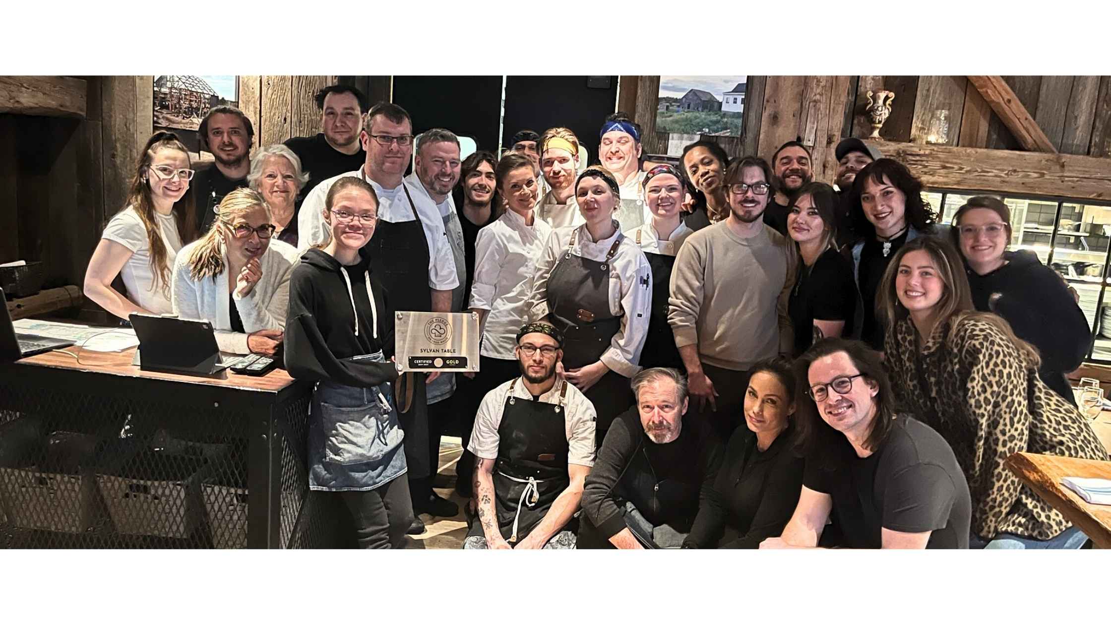 The Sylvan Table team proudly displays their Gold Level certification plaque from The PLEDGE on Food Waste.