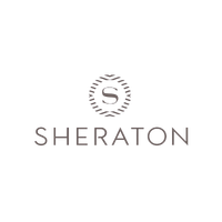 A light brown or taupe Sheraton logo featuring a stylized letter "S" enclosed in a circular laurel wreath pattern, above the word "SHERATON" in a clean sans-serif font.